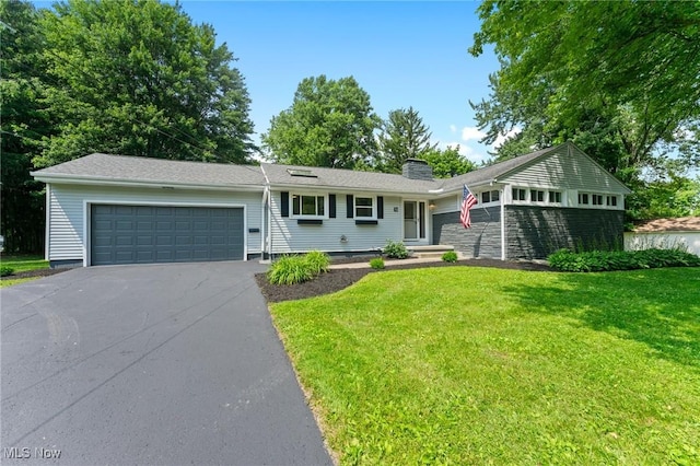 70 Maple St, Canfield, OH 44406 - ranch-style home with a garage, a front yard, a chimney, and asphalt driveway
