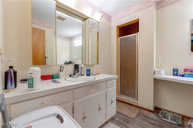 1715 High St, Louisville, OH 44641 - bathroom with a stall shower, vanity, and wood finished floors