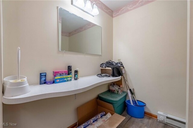 1715 High St, Louisville, OH 44641 - bathroom featuring a baseboard radiator and wood finished floors