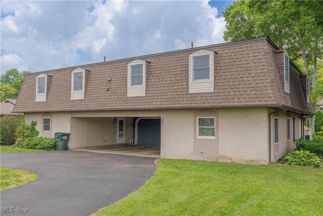 1715 High St, Louisville, OH 44641 - view of front of property with mansard roof, stucco siding, roof with shingles, an attached garage, and driveway