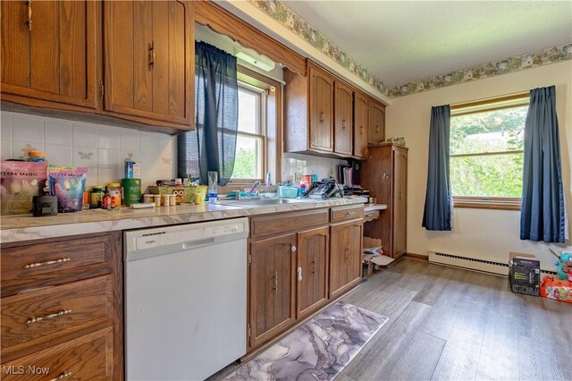 1715 High St, Louisville, OH 44641 - kitchen featuring white dishwasher, a baseboard heating unit, light wood-style floors, brown cabinets, and light countertops