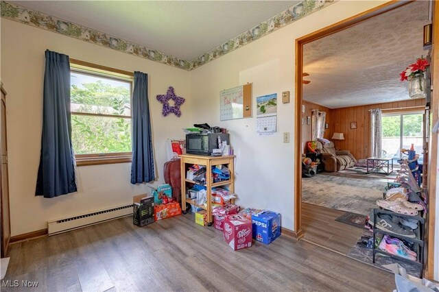 1715 High St, Louisville, OH 44641 - misc room featuring a baseboard radiator, wood finished floors, and wooden walls