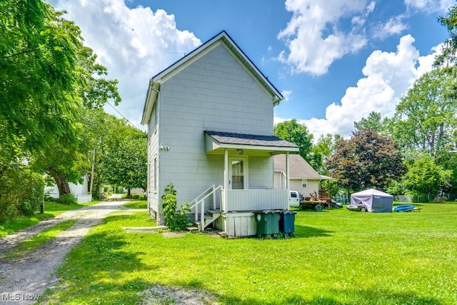 2217 Kimball Ct, Akron, OH 44314 - back of property with dirt driveway and a lawn
