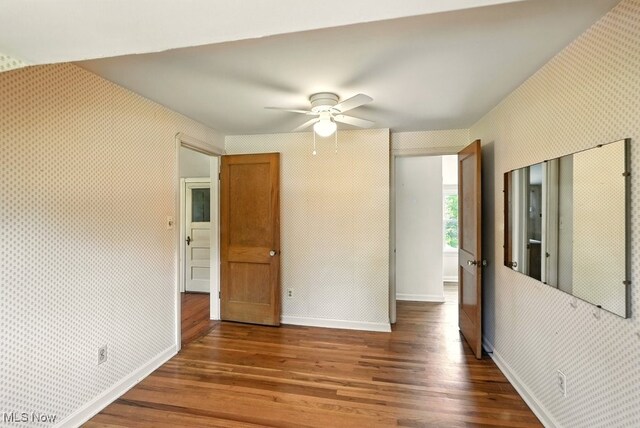 5105 E Sprague Rd, Independence, OH 44131 - empty room with wood finished floors, ceiling fan, and wallpapered walls