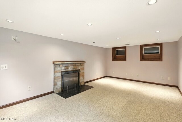 5105 E Sprague Rd, Independence, OH 44131 - unfurnished living room with light colored carpet, recessed lighting, and a stone fireplace