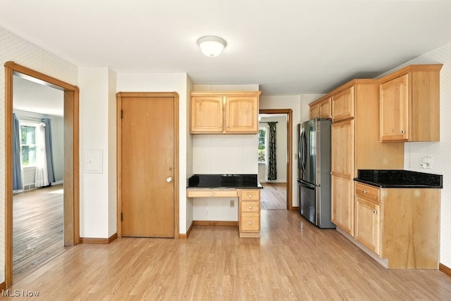 5105 E Sprague Rd, Independence, OH 44131 - kitchen with freestanding refrigerator, light wood finished floors, wallpapered walls, light brown cabinets, and dark countertops