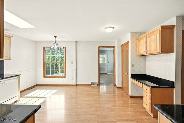 5105 E Sprague Rd, Independence, OH 44131 - kitchen featuring dishwasher, light wood finished floors, healthy amount of natural light, and light brown cabinetry
