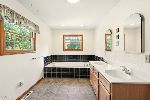 5105 E Sprague Rd, Independence, OH 44131 - bathroom with healthy amount of natural light, a garden tub, double vanity, and recessed lighting