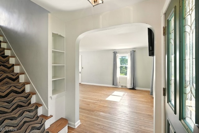 5105 E Sprague Rd, Independence, OH 44131 - foyer featuring arched walkways, light wood-type flooring, and stairs