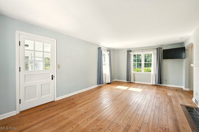 5105 E Sprague Rd, Independence, OH 44131 - unfurnished living room with hardwood / wood-style flooring and arched walkways