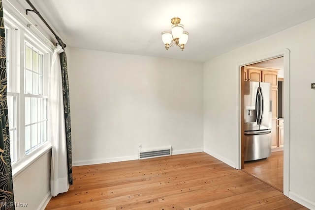 5105 E Sprague Rd, Independence, OH 44131 - unfurnished room with light wood-style floors and a chandelier