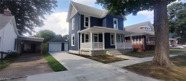 1134 E Main St, Coshocton, OH 43812 - view of front of house with a porch, an outbuilding, concrete driveway, and a garage