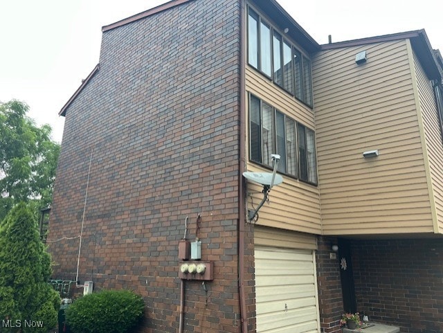 2091 Penguin Ave, Akron, OH 44319 - view of side of property with an attached garage and brick siding