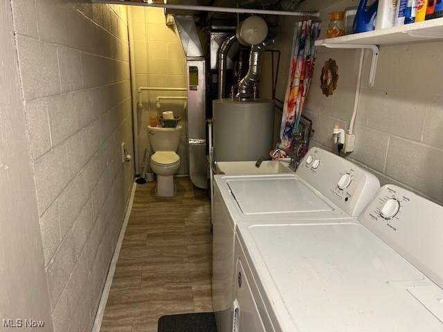 2091 Penguin Ave, Akron, OH 44319 - washroom with washing machine and clothes dryer, water heater, wood finished floors, and concrete block wall
