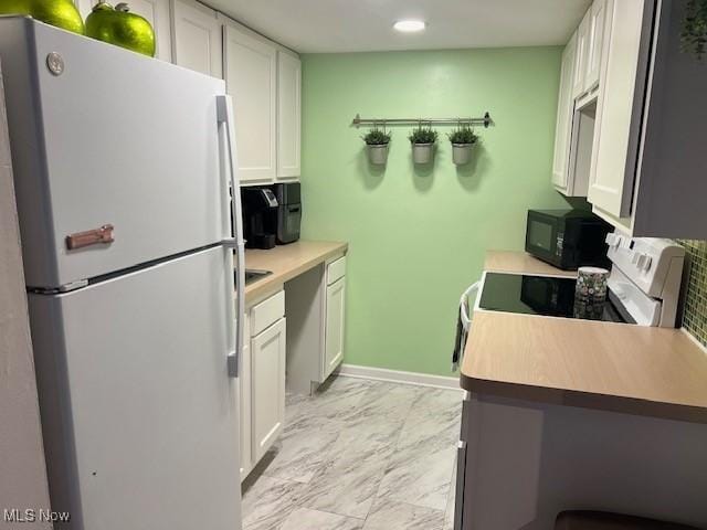 2091 Penguin Ave, Akron, OH 44319 - kitchen featuring white appliances, light marble finish flooring, white cabinetry, light countertops, and recessed lighting