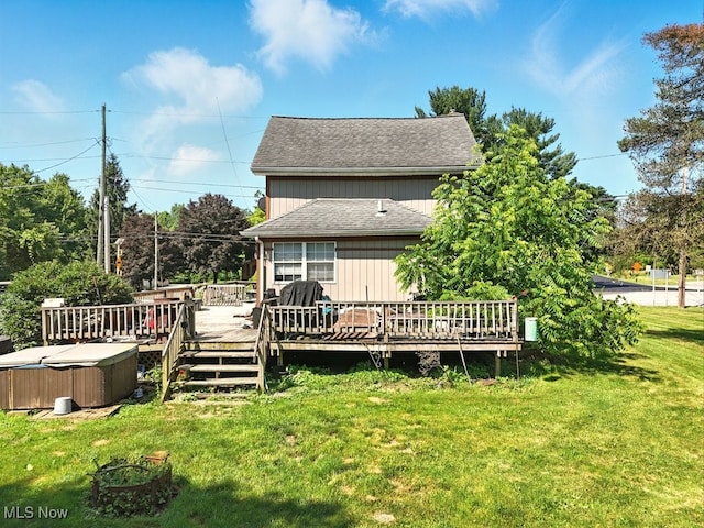 8505 Olde 8 Rd, Northfield Center, OH 44067 - rear view of house with a hot tub, a yard, roof with shingles, and a deck