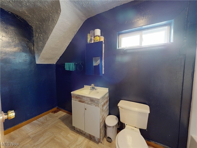 2027 Lexington Ave, Lorain, OH 44052 - half bath with vaulted ceiling, vanity, and a textured ceiling