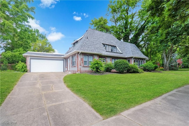 1120 Delia Ave, Akron, OH 44320 - view of front of home with brick siding, concrete driveway, and a front lawn