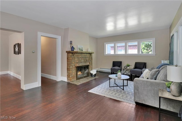 1120 Delia Ave, Akron, OH 44320 - living room featuring wood finished floors, a fireplace, and a baseboard radiator