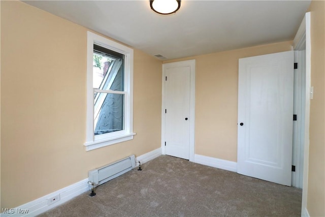 1120 Delia Ave, Akron, OH 44320 - unfurnished bedroom featuring a baseboard heating unit and carpet floors