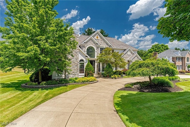 4837 Arbour Green Dr, Bath, OH 44333 - view of front facade featuring stone siding and a front lawn
