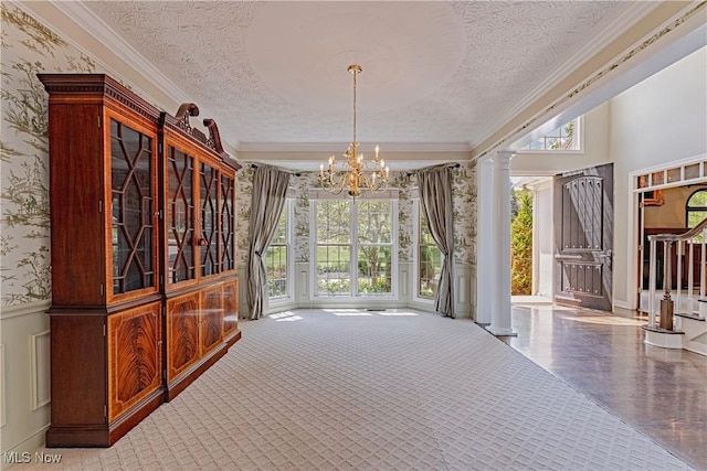 4837 Arbour Green Dr, Bath, OH 44333 - unfurnished dining area featuring wallpapered walls, healthy amount of natural light, a textured ceiling, decorative columns, and a chandelier