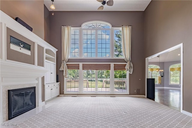 4837 Arbour Green Dr, Bath, OH 44333 - unfurnished living room with a high ceiling, a fireplace, healthy amount of natural light, and carpet flooring