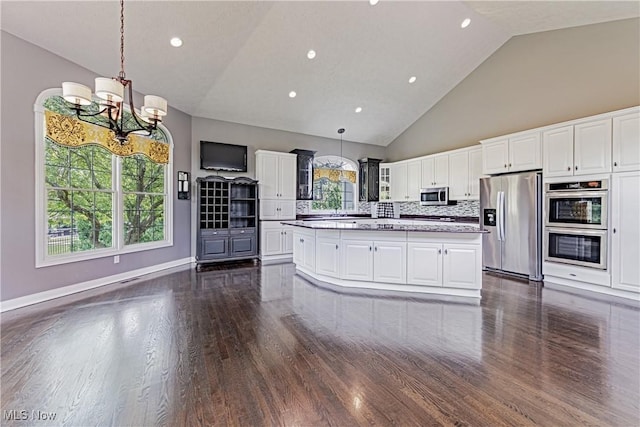 4837 Arbour Green Dr, Bath, OH 44333 - kitchen featuring appliances with stainless steel finishes, dark wood-style floors, light countertops, white cabinetry, and high vaulted ceiling