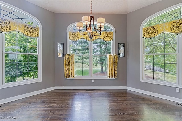 4837 Arbour Green Dr, Bath, OH 44333 - unfurnished dining area with a chandelier, plenty of natural light, dark wood finished floors, and a textured ceiling