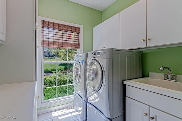 4837 Arbour Green Dr, Bath, OH 44333 - washroom with cabinet space, healthy amount of natural light, and separate washer and dryer