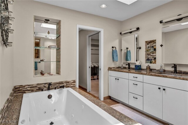 561 Willard Rd, Aurora, OH 44202 - bathroom featuring double vanity, a whirlpool tub, and recessed lighting