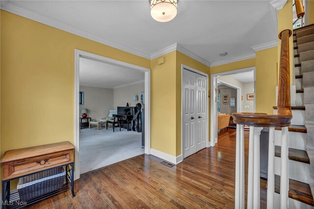 561 Willard Rd, Aurora, OH 44202 - corridor with wood finished floors, stairway, and ornamental molding
