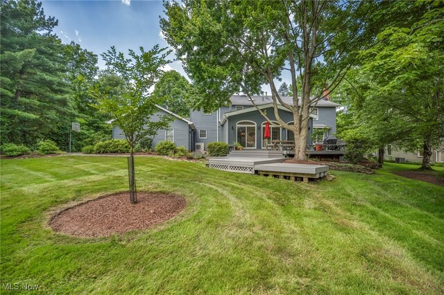 561 Willard Rd, Aurora, OH 44202 - view of front of house with a front lawn and a wooden deck