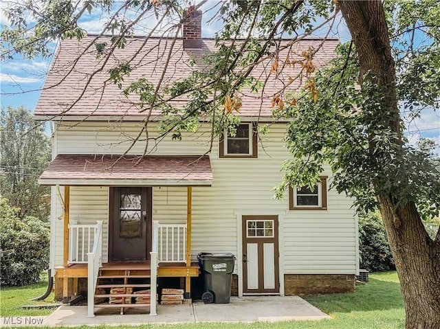 114 Hillcrest St, Ravenna, OH 44266 - back of property with a chimney, roof with shingles, and a lawn