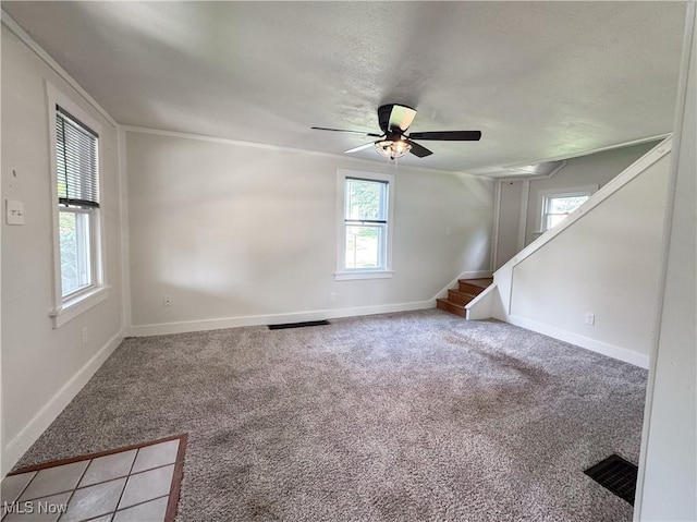 114 Hillcrest St, Ravenna, OH 44266 - empty room with light colored carpet, stairway, a ceiling fan, and ornamental molding