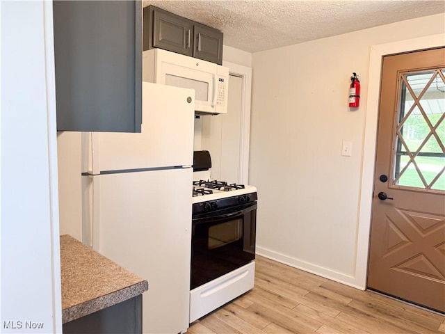 114 Hillcrest St, Ravenna, OH 44266 - kitchen with white appliances, light wood-style flooring, a textured ceiling, and light countertops