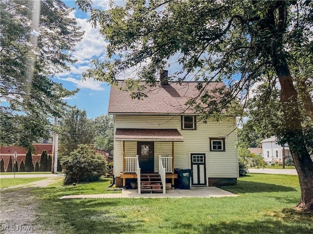 114 Hillcrest St, Ravenna, OH 44266 - back of property with a lawn and a shingled roof