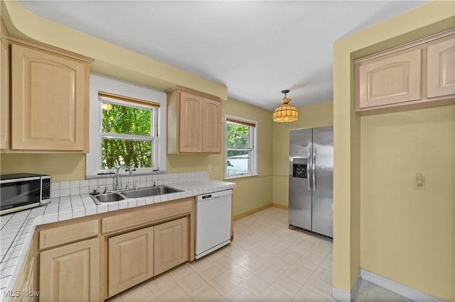 4038 Wandsworth Rd, South Euclid, OH 44121 - kitchen featuring stainless steel appliances, light brown cabinetry, tile counters, and light flooring