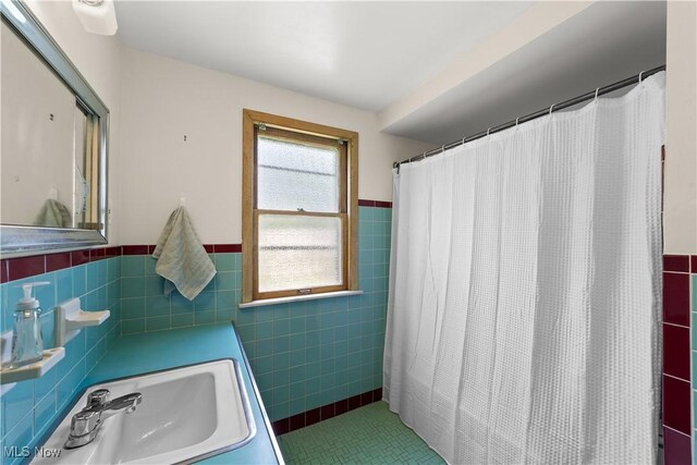 4038 Wandsworth Rd, South Euclid, OH 44121 - bathroom featuring tile walls, a wainscoted wall, tile patterned floors, and a shower with shower curtain