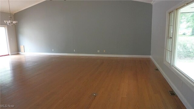 1519 Mctaggart Rd, Stow, OH 44224 - spare room with wood finished floors, a chandelier, and ornamental molding