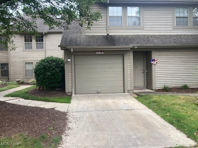 205 S Aspen Unit 4, Warren, OH 44484 - view of front facade featuring an attached garage, driveway, and roof with shingles