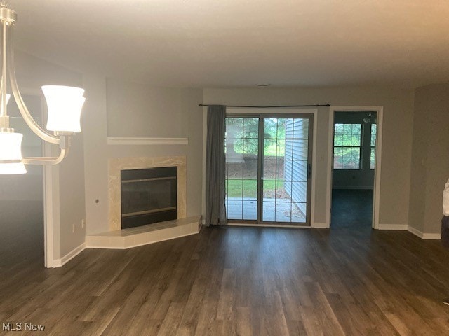 205 S Aspen Unit 4, Warren, OH 44484 - unfurnished living room with dark wood-style floors and a tile fireplace