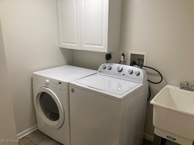 205 S Aspen Unit 4, Warren, OH 44484 - laundry area featuring washer and dryer, cabinet space, and light tile patterned floors