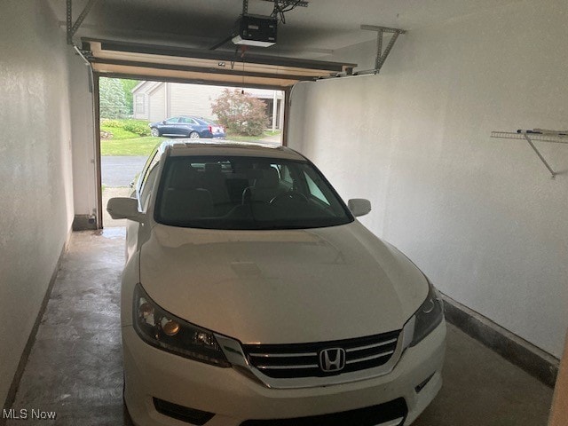 205 S Aspen Unit 4, Warren, OH 44484 - garage featuring a garage door opener and baseboards