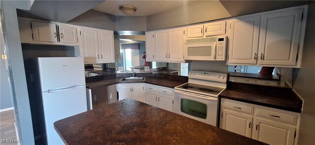 2202 Acacia Park Dr Unit 2605, Lyndhurst, OH 44124 - kitchen featuring white appliances, dark countertops, and white cabinetry