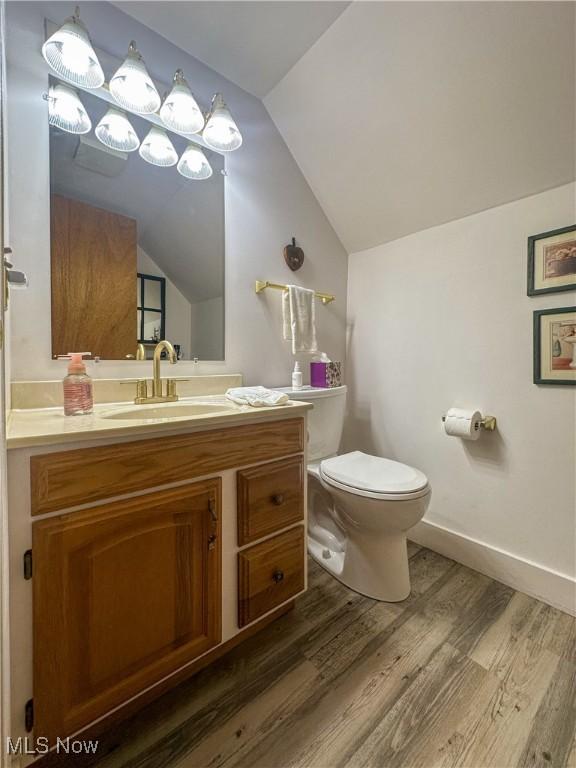 30 Bond St, Niles, OH 44446 - half bathroom with lofted ceiling, wood finished floors, and vanity