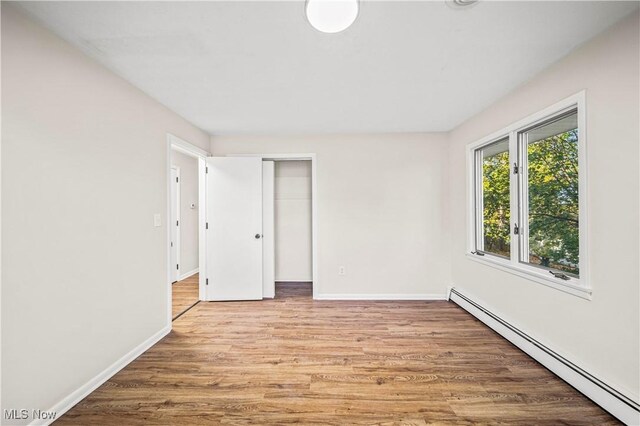 30529 Ridge Rd, Wickliffe, OH 44092 - empty room with a baseboard radiator and wood finished floors