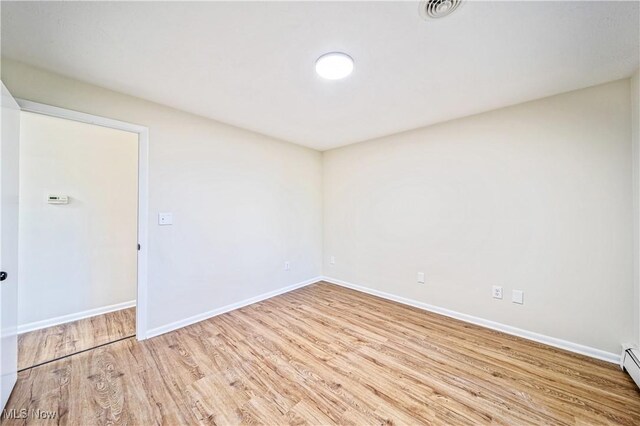 30529 Ridge Rd, Wickliffe, OH 44092 - unfurnished room with wood finished floors and a baseboard heating unit