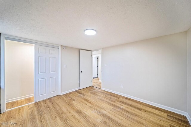 30529 Ridge Rd, Wickliffe, OH 44092 - unfurnished bedroom with light wood-style floors and a textured ceiling