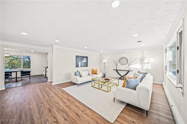 30529 Ridge Rd, Wickliffe, OH 44092 - living room featuring a textured ceiling, recessed lighting, wood finished floors, and baseboard heating